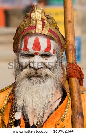 VARANASI INDIA NOVEMBER 30 An unidentified Hindu holy man seeks alms in front of a ghat along the river Ganges on November 30 2012 at Varanasi Uttar Pradesh India VARANASI INDIA NOVEMBER 30 An unidentified Hindu holy man seeks alms in front of a ghat along the river Ganges on November 30 2012 at Varanasi Uttar Pradesh India