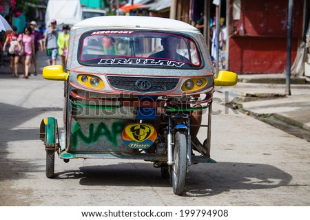EL NIDO, PHILIPPINES - FEBRUARY 2, 2014 :Tricycle motor taxi, Philippines inexpensive transport service. Tricycle motor taxi are the most popular means of public transportation in the Philippines.