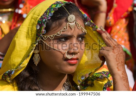 PUSHKAR, INDIA - NOVEMBER 21, 2012 : An unidentified girl attends the Pushkar fair, Rajasthan, India. Pilgrims and camel traders flock to the holy town for the annual fair.