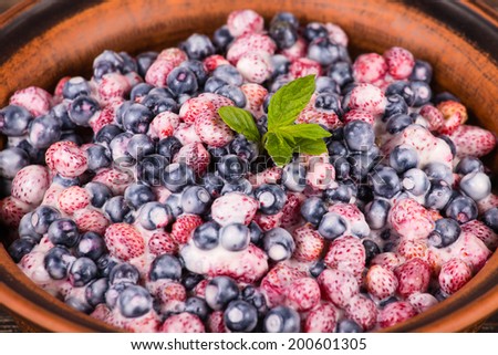 Fresh fruit salad with strawberries and blueberries , wild berry