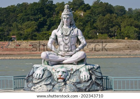 RISHIKESH INDIA-OCTOBER 24 2012 Statue Shiva hindu idol on the river Ganges RISHIKESH INDIA-OCTOBER 24 2012 Statue Shiva hindu idol on the river Ganges