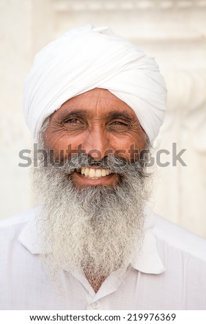AMRITSAR, INDIA - SEPTEMBER 26, 2014: Unidentified Sikh man visiting the Golden Temple in Amritsar, Punjab, India. Sikh pilgrims travel from all over India to pray at this holy site.