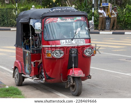 MATARA, SRI LANKA - NOVEMBER 5, 2014: Auto rickshaw or tuk-tuk on the street of Matara. Most tuk-tuks in Sri Lanka are a slightly modified Indian Bajaj model, imported from India.