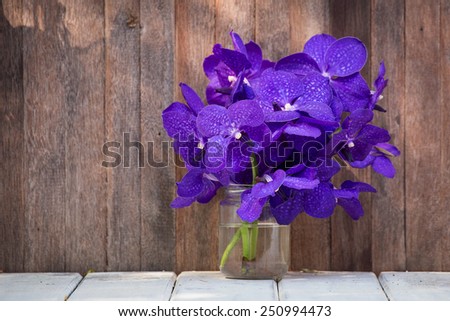 Closeup beautiful bouquet of orchids flower on a wooden background