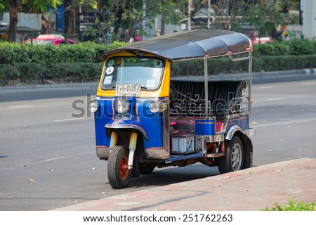 BANGKOK,THAILAND - JANUARY 8, 2015:  Auto rickshaw or tuk-tuk on the street of Bangkok.Tuk tuks are commonly used in transporting people and goods around the capital