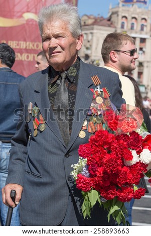 KIEV, UKRAINE - MAY 9, 2013: Ceremonial parade at Kiev main street Khreschatyk dedicated to the 68th anniversary of victory in Great Patriotic War ( World War II ). Unidentified participant