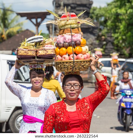 UBUD, BALI, INDONESIA - MARCH 19, 2015 : Unidentified Indonesian people celebrate Balinese New Year and the arrival of spring. Balinese women bring offerings of fruits and gifts to the village temple