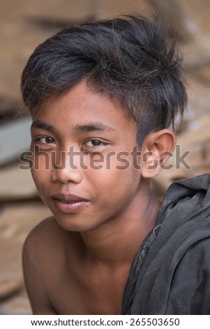 UBUD, BALI, INDONESIA - MARCH 29, 2015 : Portrait of unknown young guy working in carpentry shop. Teens in Indonesia started his career very early age