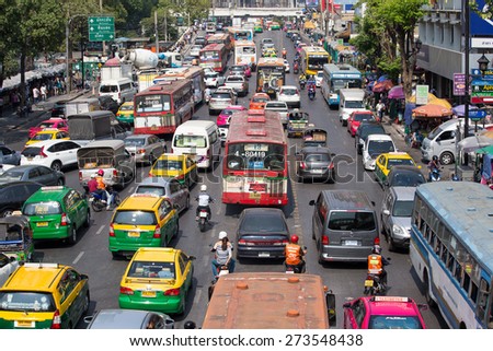 BANGKOK, THAILAND - JANUARY 22, 2015: Traffic moves slowly along a busy road in Bangkok, Thailand. Annually an estimated 150,000 new cars join the already heavily congested streets of Bangkok.