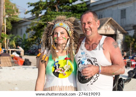 KOH PHANGAN,THAILAND - MAY 3, 2014: Unidentified man and women participate in the Full Moon party on island Koh Phangan. The event now attracts anywhere from 40,000 party-goers on a normal month