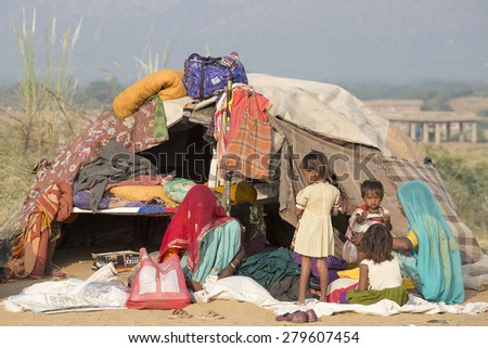 PUSHKAR, INDIA - OCTOBER 27, 2014: Unidentified women and children at the the annual Pushkar Camel Mela. This fair is the largest camel trading fair in the world.