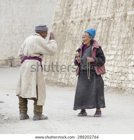 LAMAYURU, INDIA - JUNE 15, 2015: Unidentified buddhist old woman and man during Tsam mystery in time of Yuru Kabgyat festival at Lamayuru Gompa, Ladakh, North India