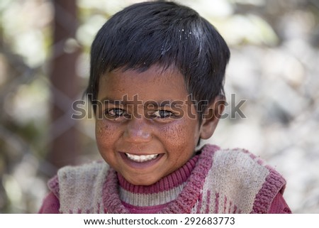 LEH, INDIA - JUNE 26, 2015: Unidentified beggar girl on the street in Leh, Ladakh. Poverty is a major issue in India