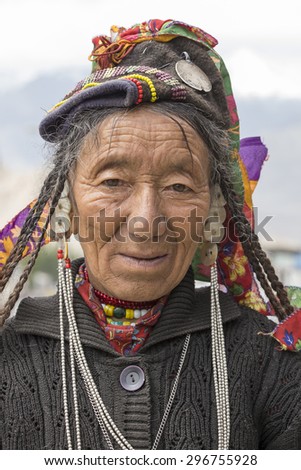 LEH, INDIA - JUNE 21, 2015: Unknown beggar woman begging on the street in Leh, Ladakh. Poverty is a major issue in India