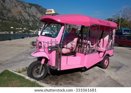 KOTOR, MONTENEGRO - SEPTEMBER 23, 2015 : Pink auto rickshaw or tuk-tuk on the street of Kotor. Tuk tuks are commonly used in transporting tourists. This transport is very popular in Thailand and India