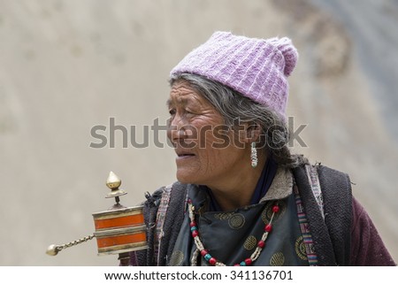 LAMAYURU, INDIA - JUNE 13, 2015: Unidentified buddhist old women during mystical mask dancing Tsam mystery dance in time of Yuru Kabgyat Buddhist festival at Lamayuru Gompa, Ladakh, North India