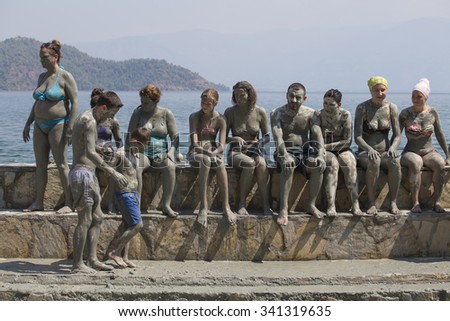 DALYAN, TURKEY - AUGUST 20, 2015 : Unidentified people are taking a mud bath. Mud baths are great for the skin.