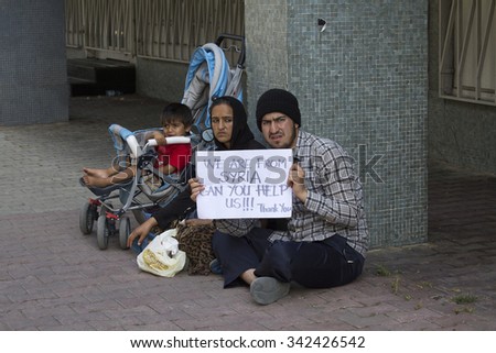 ISTANBUL, TURKEY - AUGUST 03, 2015 : Unknown refugees from Syria are asking for help on the street in Istanbul