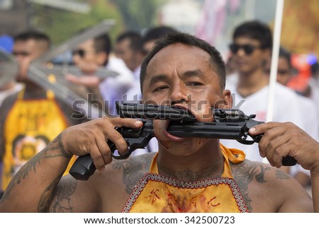 PHUKET, THAILAND - OCT 18, 2015: Chinese thai monk possessed by his god walks with his mouth pierced in Vegetarian Festival at Phuket Town. Festival is a famous annual also known as Nine Emperor Gods