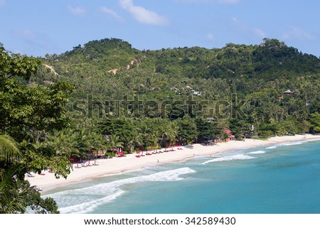 KOH PHANGAN, THAILAND - NOVEMBER 21, 2015 : Beautiful Thong Nai Pan Noi Beach with palm trees and bungalows for tourists. On the island Koh Phangan each month passes full moon party for tourists
