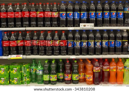 PATTAYA, THAILAND - NOVEMBER 16, 2014: Shelves with bottles of Coca Cola, Pepsi Cola, Fanta and Sprite in Central Festival Pattaya Beach mall. Thailand