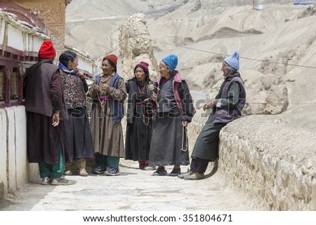 LAMAYURU, INDIA - JUNE 15, 2015: Unidentified buddhist old women during mystical mask dancing Tsam mystery dance in time of Yuru Kabgyat Buddhist festival at Lamayuru Gompa, Ladakh, North India