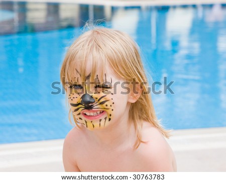 Girl with paint on his face in the pool