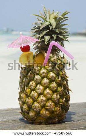 Tropical pineapple cocktail drink at the beach overlooking the ocean