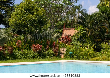 Swimming pool in garden, Thailand