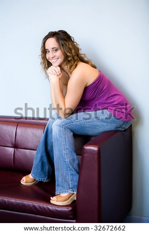 teen girl sitting on couch