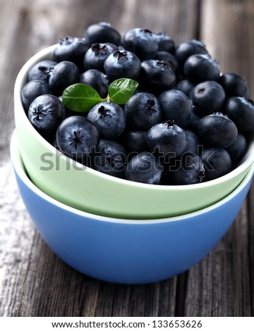 Fresh ripe blueberries in the colored plates