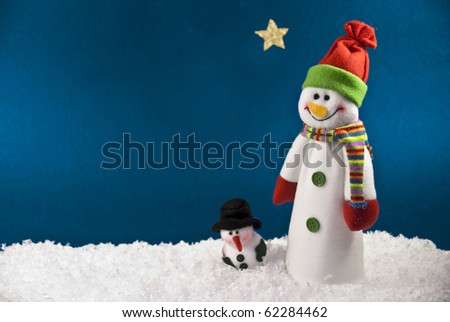 Two Snowmen against a Blue Night Sky with room for your writing