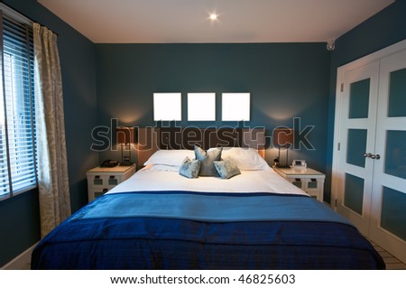 A luxurious modern bedroom on a bright morning. Wardrobe to one side, with window to the other, and three blank square boxes above the bed for your design/text.