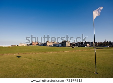 The flag on the first hole of the famous Old Course links in St Andrews on a clear sunny afternoon.