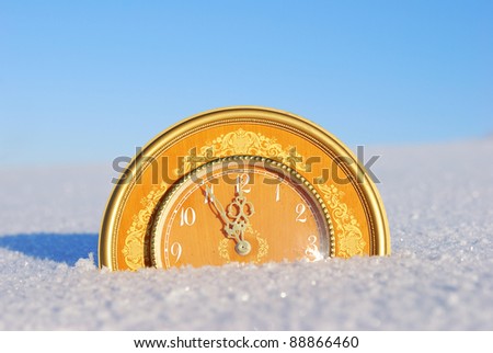 Clock showing the arrival of  new year on winter background