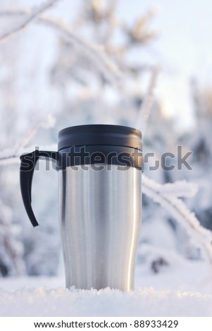Heat protection-thermos coffee cup on winter day