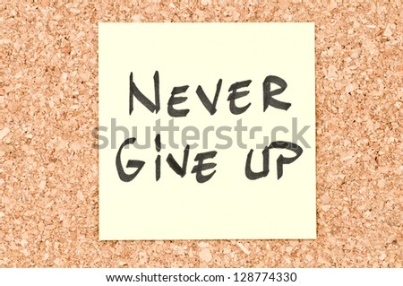 Never Give Up, handwritten on a sticky note