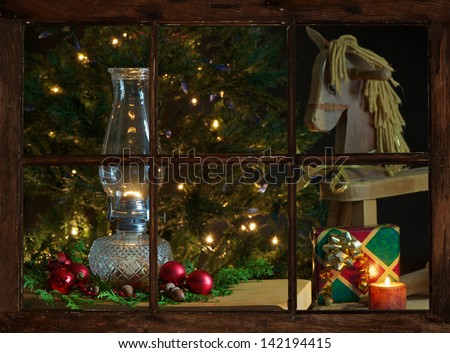 View of a living room decorated for Christmas, as seen through the farmhouse window at night.
