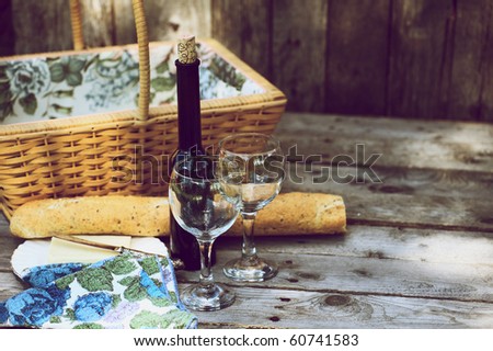 Country picnic for two with wine, bread and cheese.