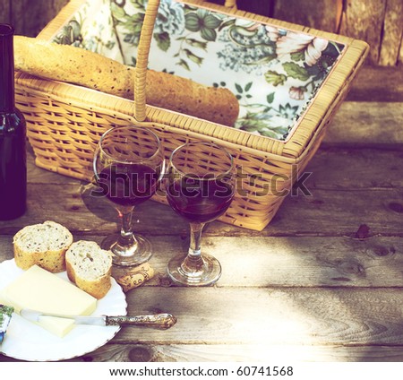 Country picnic for two with wine, bread and cheese.