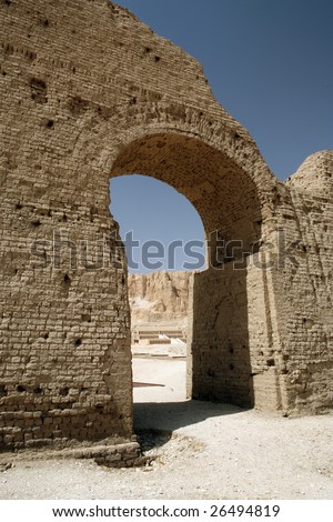 Temple of Queen Hatshepsut framed by an archway of a nearby ruined temple, Egypt
