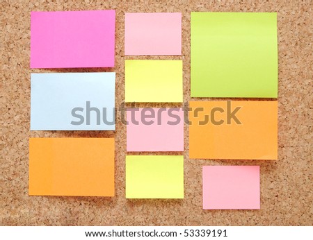 sticky notes over brown cork background