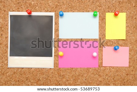 colorful empty notes over brown cork background