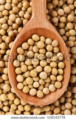 Top view of handmade wooden spoon full of soybeans