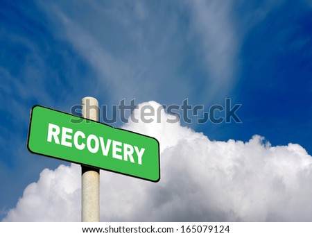Green recovery sign against a blue sky