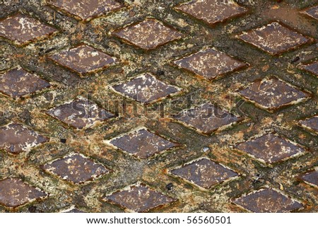 Old rusty drain cover background, diamond pattern