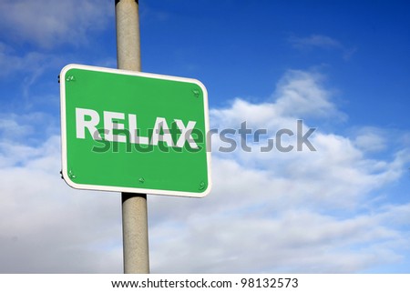 Green relax sign against a blue sky