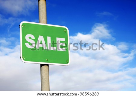 Sale sign against a blue sky