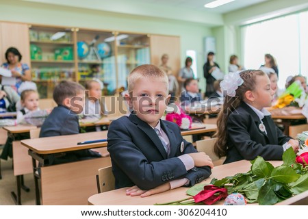 NOVOKUZNETSK, KEMEROVO REGION, RUSSIA - SEPTEMBER, 1, 2014: First-grade students and teacher are in school classroom at first lesson. The day of knowledge in Russia.