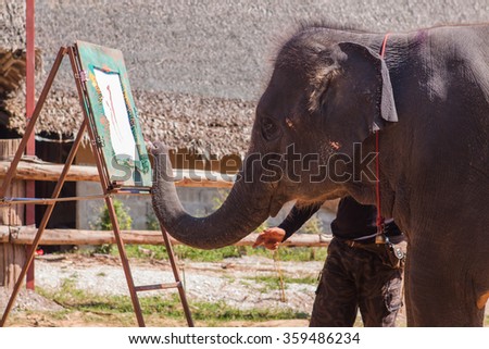 Kanchanaburi, Thailand - November 22, 2012 :: Elephant painting. Elephant show in Kanchanaburi, Thailand. November 22, 2012.